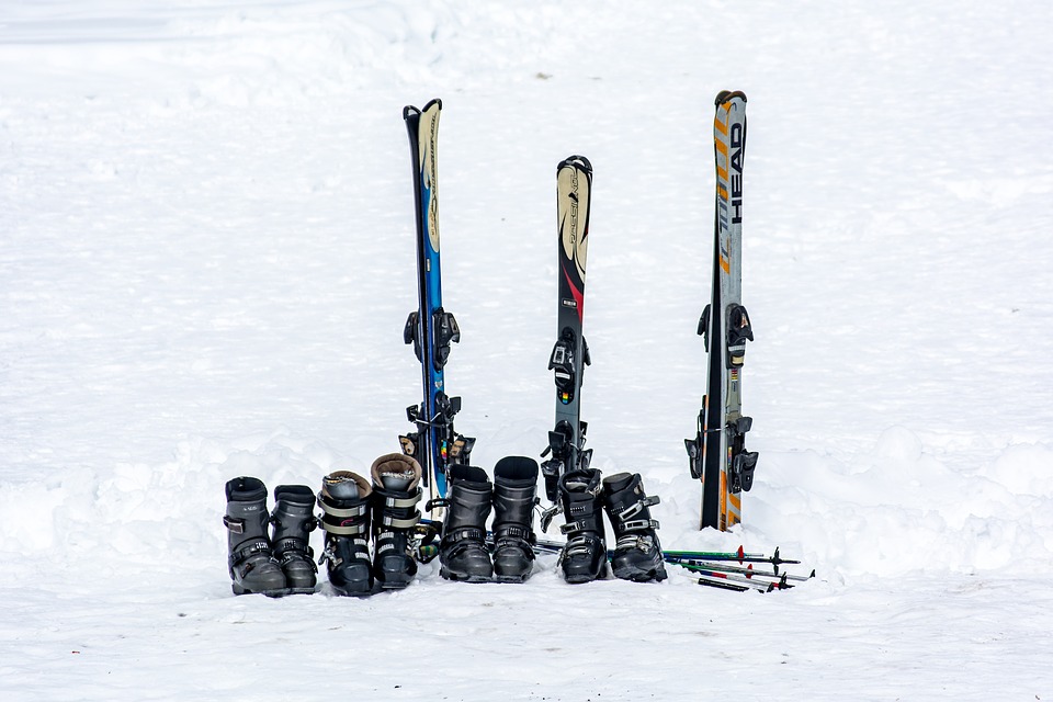 family-unit-of-classic-piste-skis-and-boots rent or buy ski gear